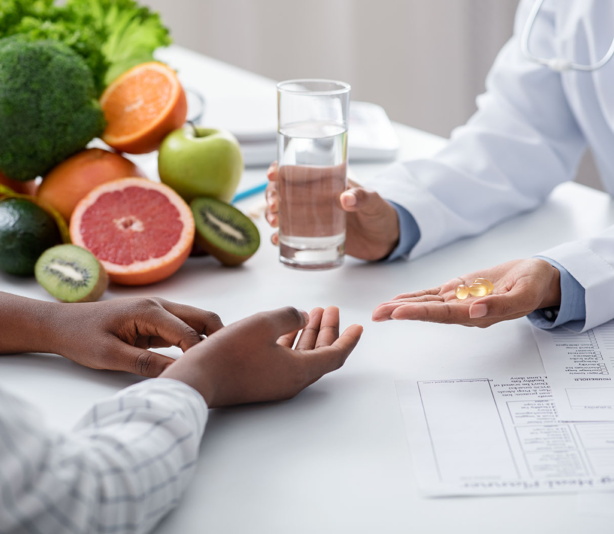 dietologist-giving-pills-and-glass-of-water-to-fem-49Z9QTF