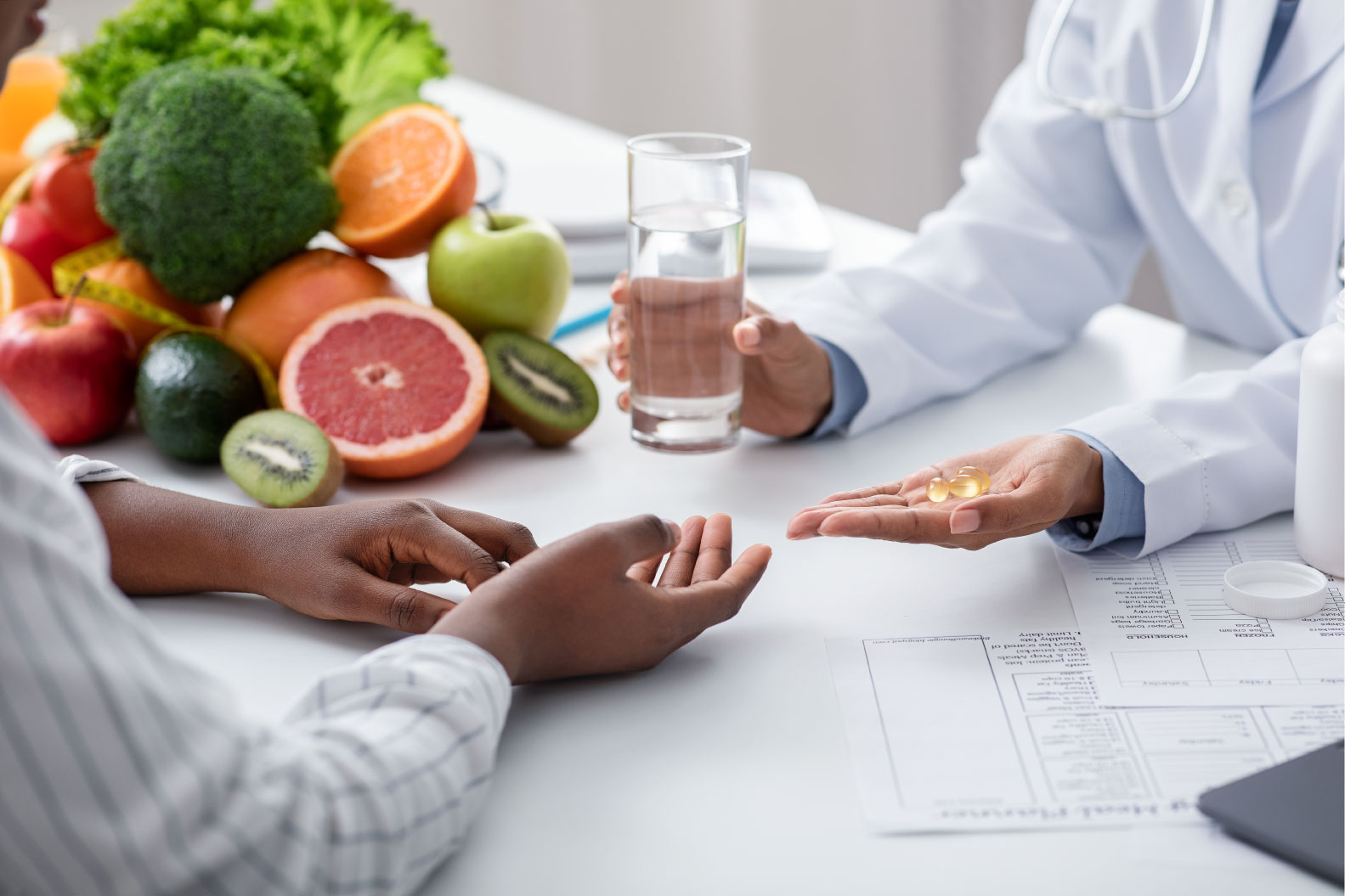 dietologist-giving-pills-and-glass-of-water-to-fem-49Z9QTF